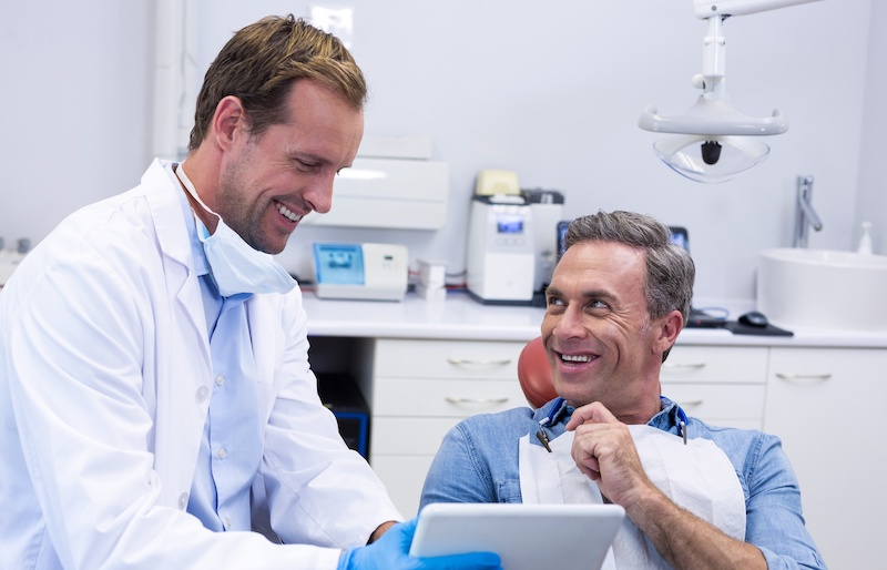 Photo of Dentist reviewing documents with patient