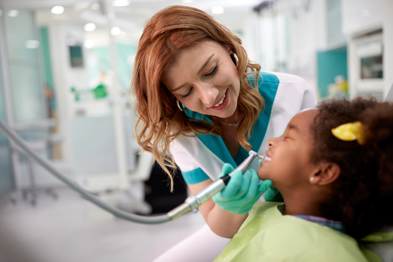 Photo of a child receiving a teeth cleaning