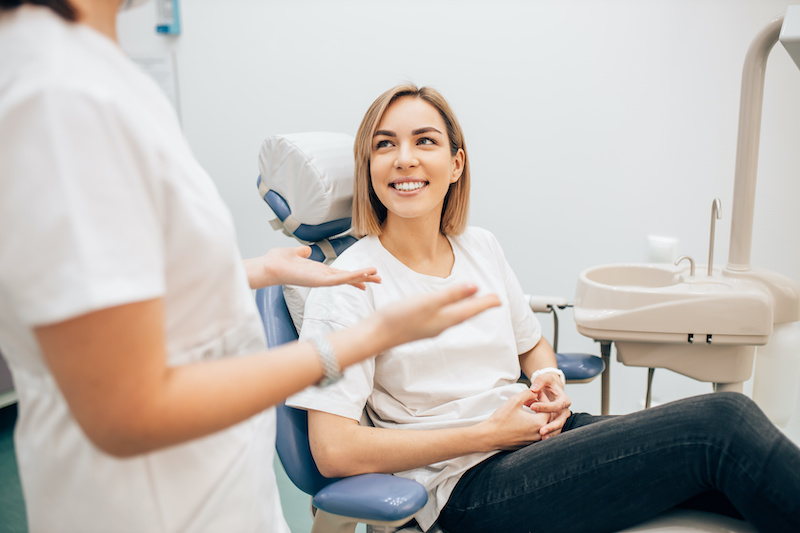 Photo of a woman having a conversation with her dentist