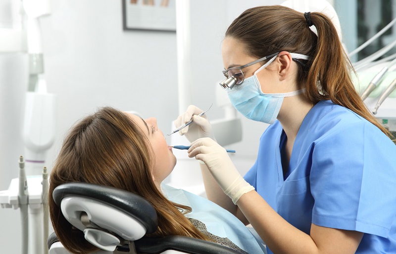 Photo of Dentist examining a patient's teeth